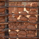 Why I Created a Database to Document African Vernacular Architecture Swaziland - wall constructed of a wood frame with rocks as filler. The wall will be plastered over. Image © Jon Sojkowski via Swaziland Architecture